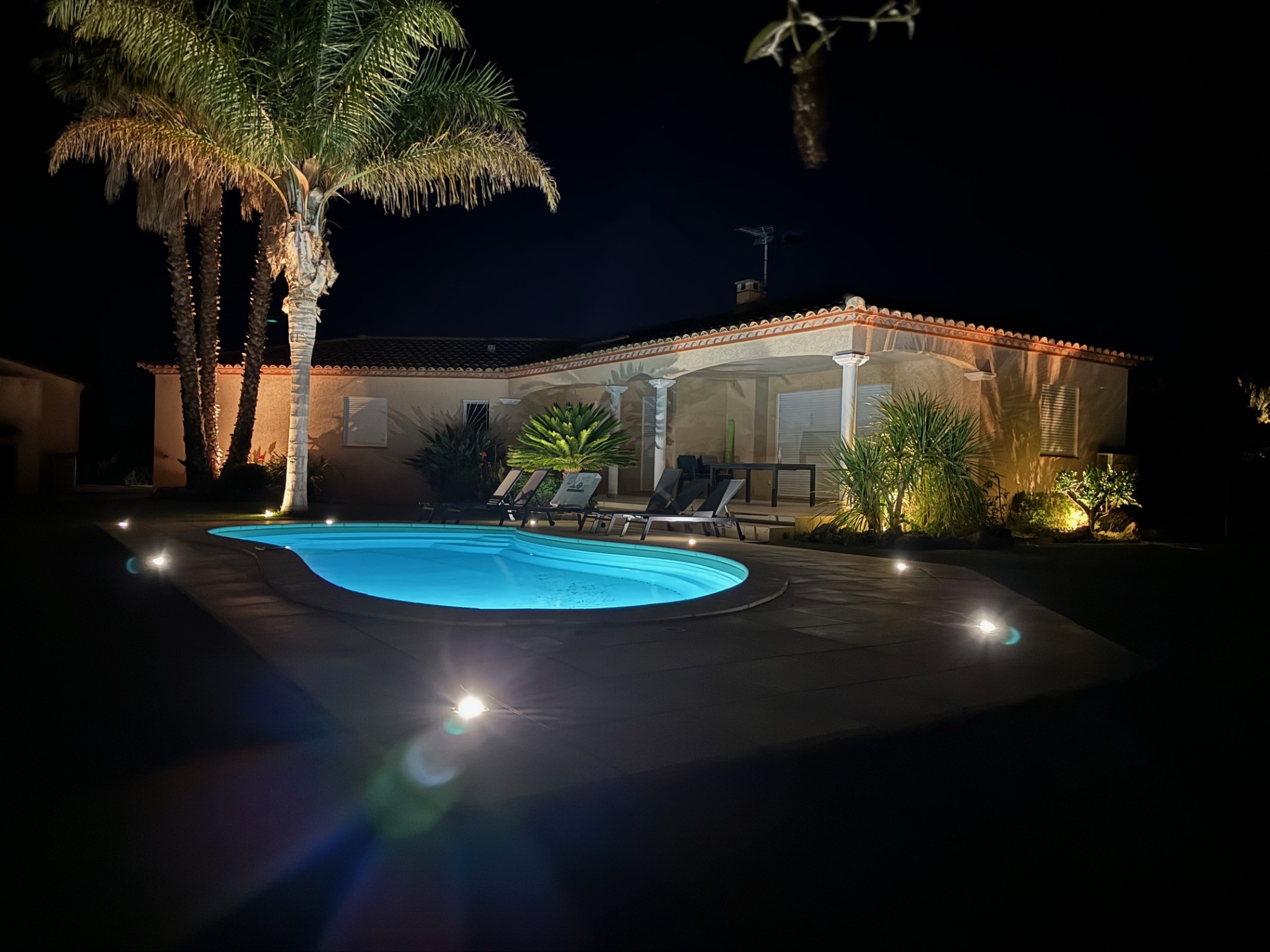 Villa de nuit avec piscine éclairée